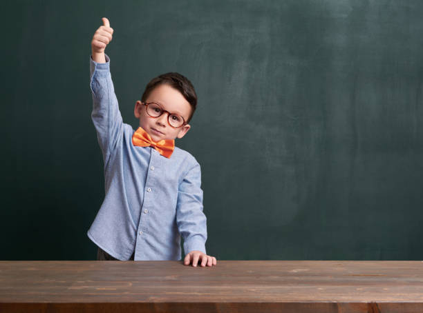 istock Cute child is in front of chalkboard 700100904