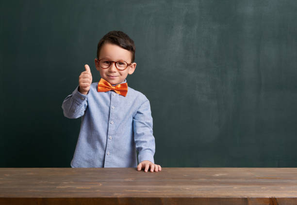 istock Cute child is in front of chalkboard 700105242