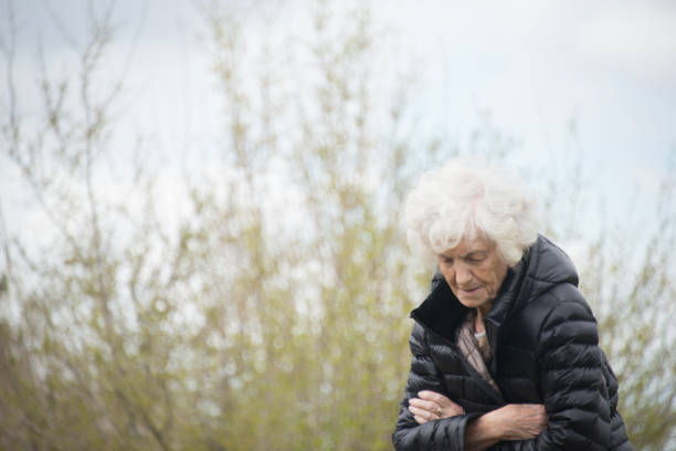 istock Senior Woman Outdoors Lost in Thoughts 700109506