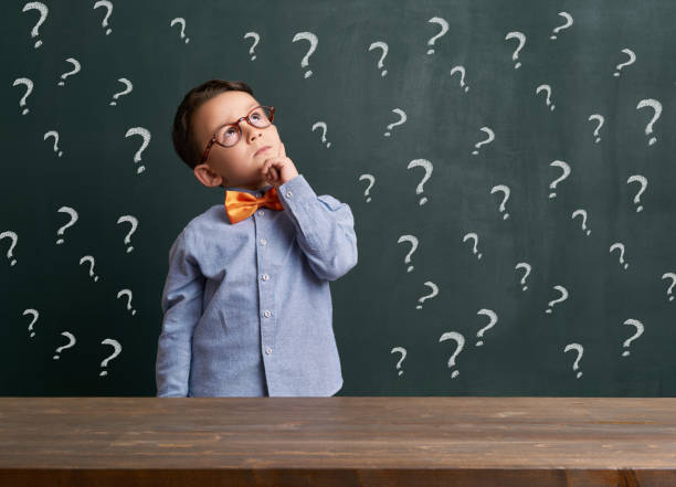 istock Cute child is in front of chalkboard 700113760