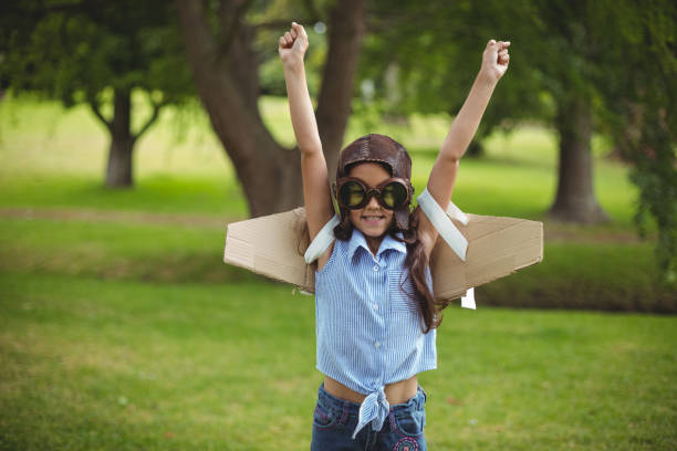 istock Young girl pretending to fly 700125764