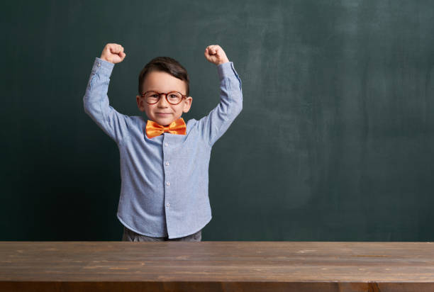 istock Strong child is in front of chalkboard 700125768