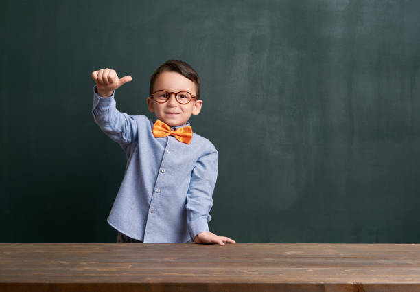 istock Cute child is in front of chalkboard 700125794