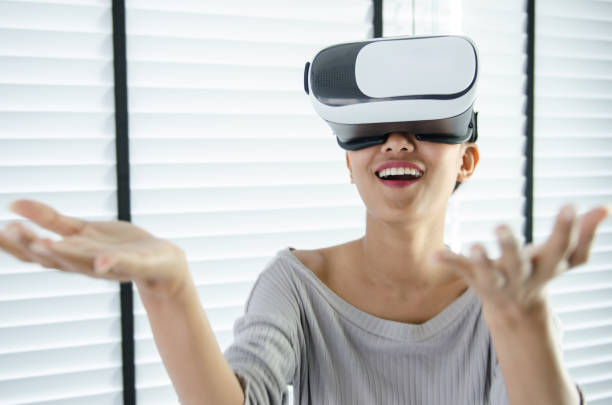istock close up woman use virtual reality glasses ( VR ) in her office 700125936