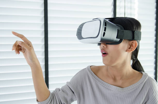 istock close up woman use virtual reality glasses ( VR ) in her office 700125942