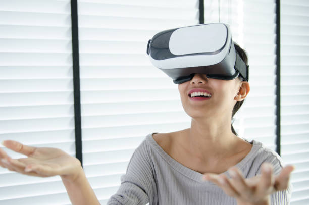 istock close up woman use virtual reality glasses ( VR ) in her office 700125962