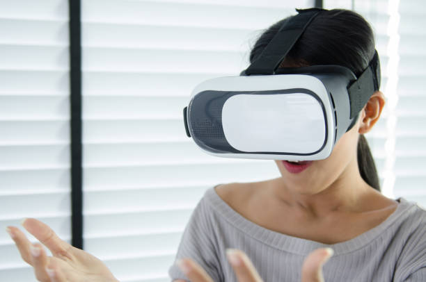 istock close up woman use virtual reality glasses ( VR ) in her office 700125966