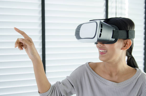 istock close up woman use virtual reality glasses ( VR ) in her office 700125974