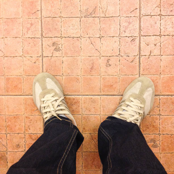 istock Sneaker shoes on tiled floor 700125990