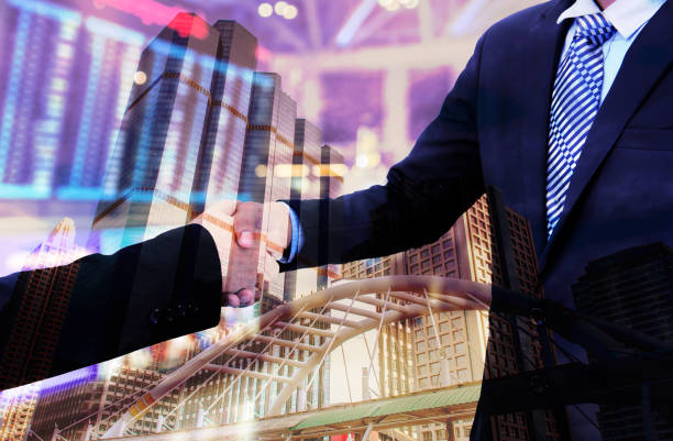 istock business handshake with city background, Double exposure style 700126232