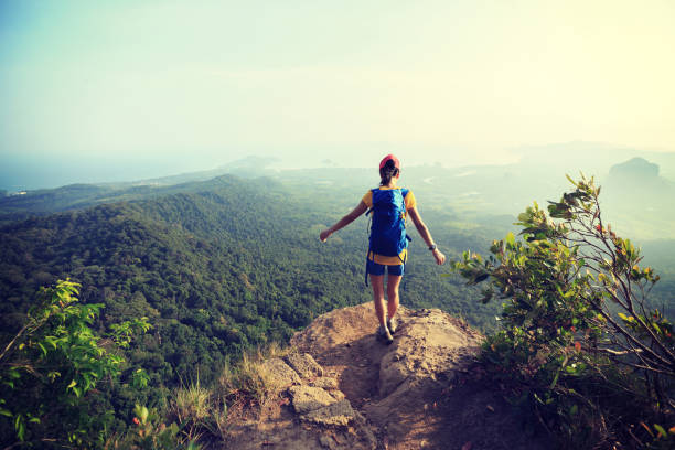 istock successful woman hiker hiking on mountain peak 700126254