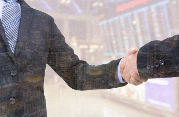 istock business handshake with city background, Double exposure style 700126294