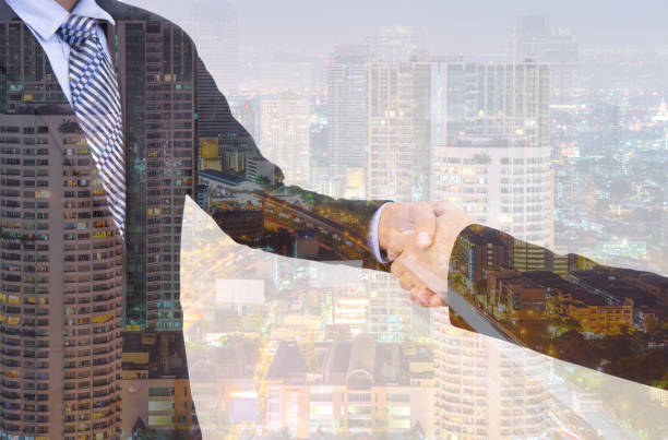 istock business handshake with city background, Double exposure style 700126366