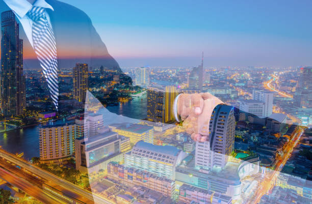 istock business handshake with city background, Double exposure style 700137206