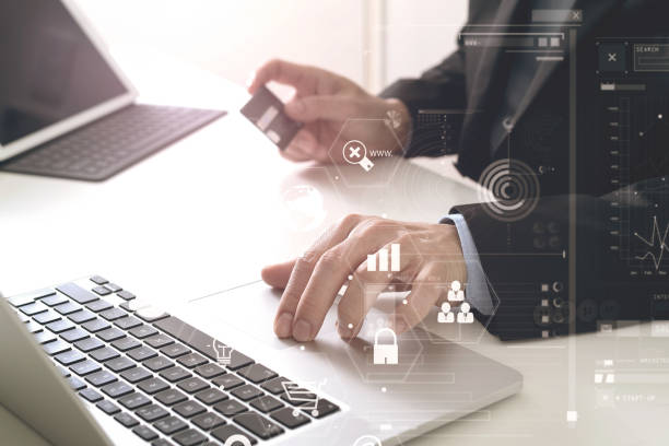 istock businessman making credit card purchase online with laptop computer on modern desk 700139304