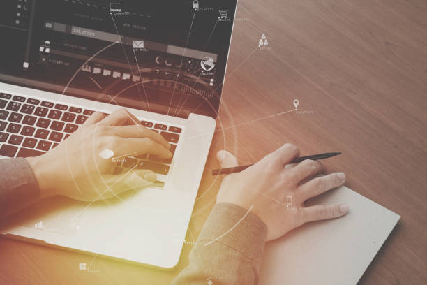 istock top view of creative working with digital computer and book with document on wooden desk in modern office with virtual icon diagram 700141546