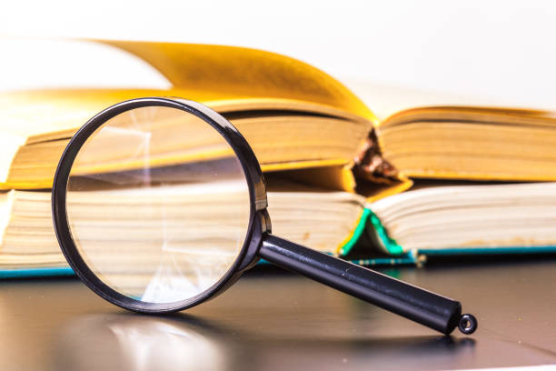 istock books and magnifying glass 700150760