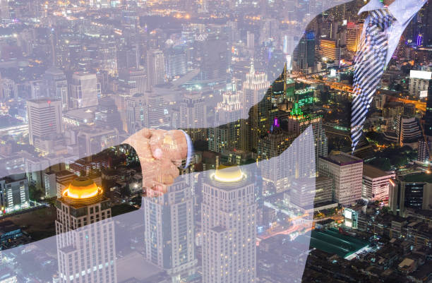 istock business handshake with city background, Double exposure style 700164068