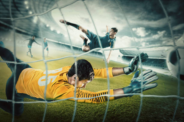 istock Goalkeeper in gates jumping to catching ball 700164356
