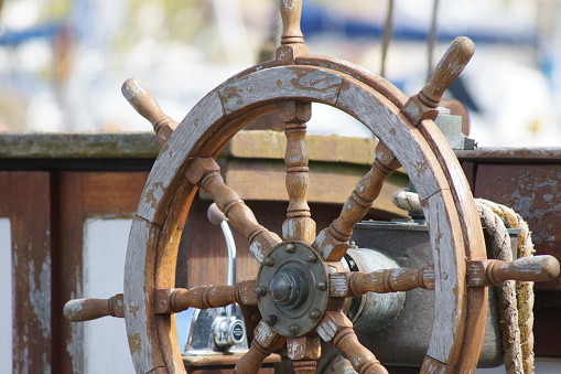 Steering wheel of a sailboat in the sea