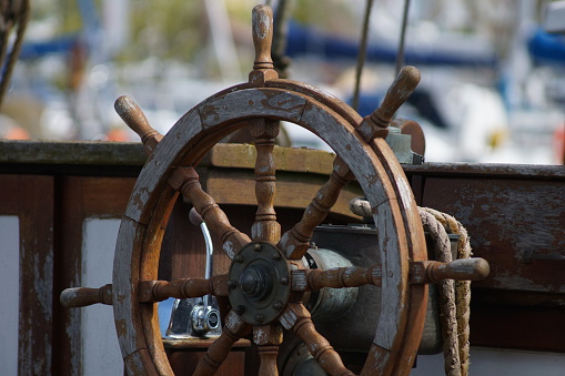 Steering wheel of a sailboat in the sea