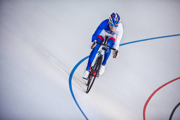 Racing cyclist on velodrome outdoor.