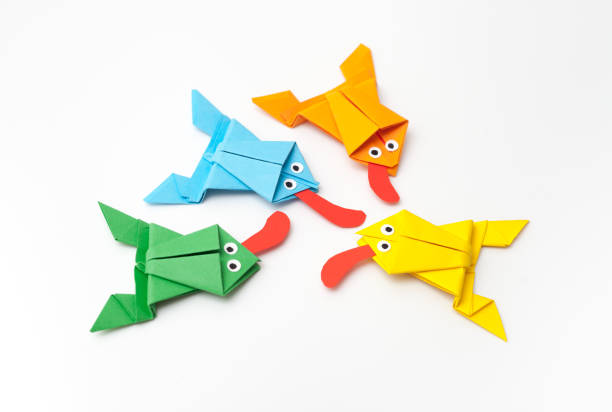 istock Frogs folded from colored paper in origami technique 700167886