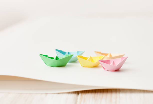 istock Paper boats from color paper on white 700168478