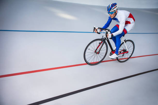 Racing cyclist on velodrome outdoor. Sport. Cyclist has a traning on a velodrome velodrome stock pictures, royalty-free photos & images