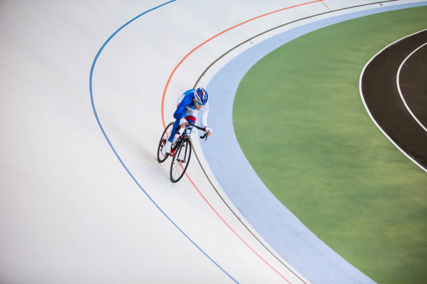 Racing cyclist on velodrome outdoor.