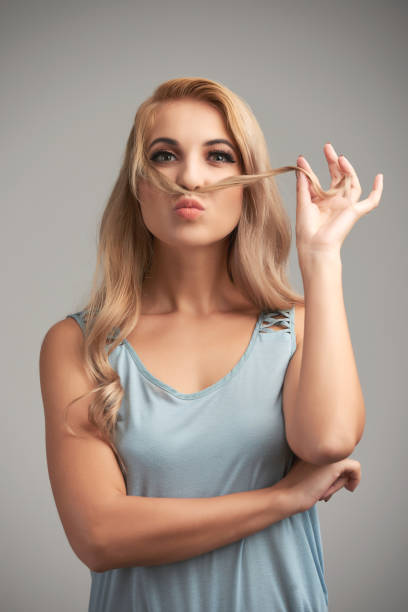 istock Playful girl with blonde mustache 700171940
