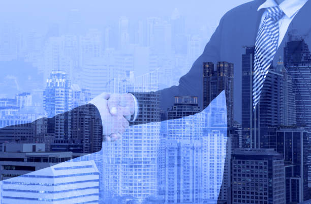 istock business handshake with city background, Double exposure style 700179798