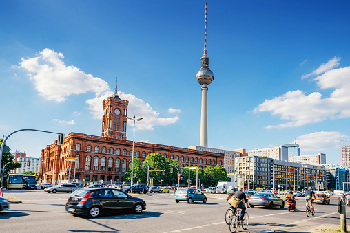 traffic in front of Red Rathaus in Berlin and TV-Tower at afternoon in summer