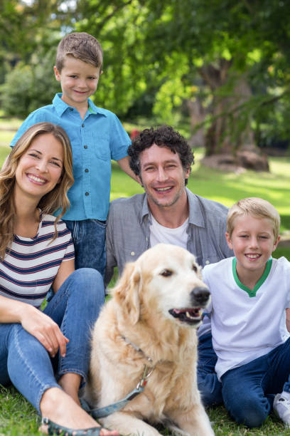 istock Family with dog in the park 700185032