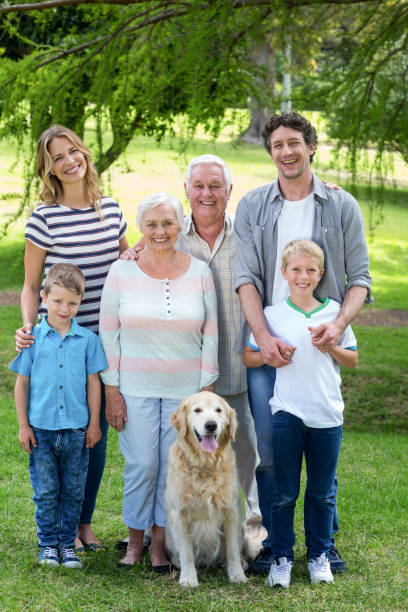 istock Family with dog in the park 700185276