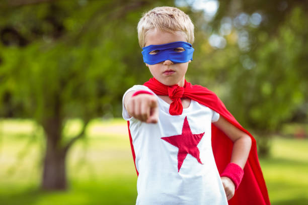 istock Little boy pretending to be superhero pointing 700189640