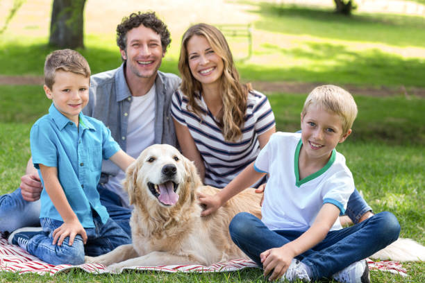 istock Family with dog in the park 700189852