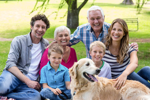 istock Family with dog in the park 700189932
