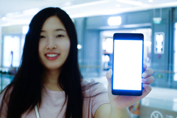 istock Woman holding mobile phone 700191158