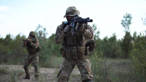 istock Soldiers aiming on battlefield 700194028