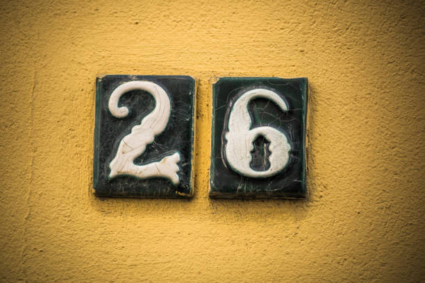 istock Number twenty six in raised figures on plaster wall 700194624