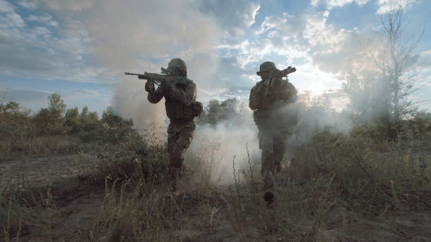 istock Military forces walking on battlefield 700194642