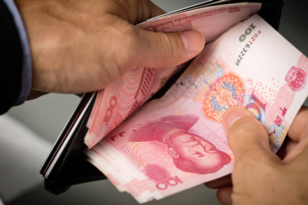 istock Hands Counting Chinese Currency, 100 Chinese Yuan in Wallet 700199516