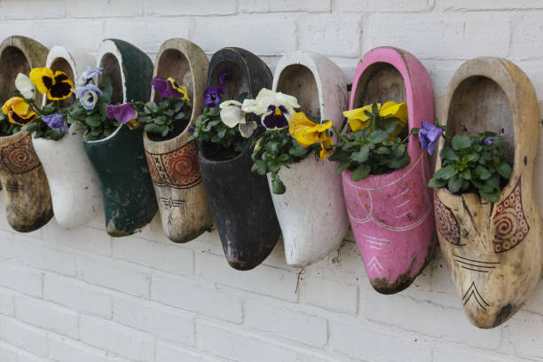 istock Old wooden clogs with blooming flowers ,Marken, The Netherlands 700200276