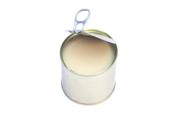 istock Condensed milk in tin can isolated on white background 700200572