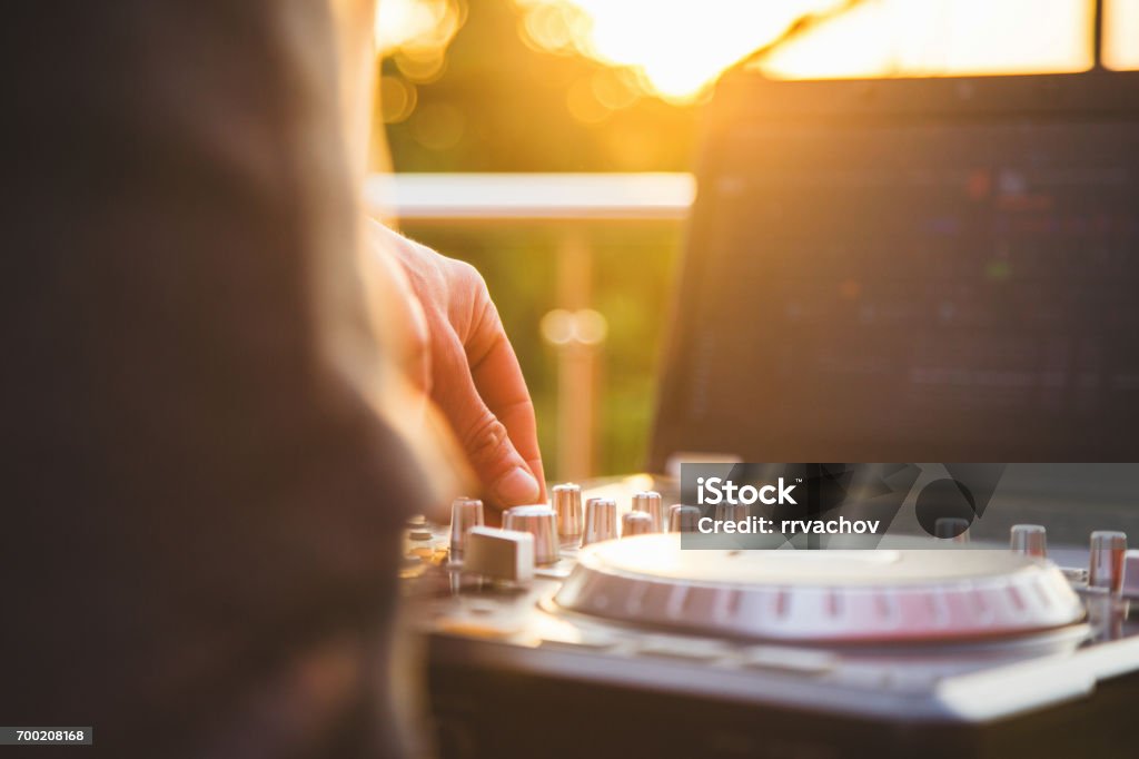 Dj mixing music outdoor. Dj mixing music outdoor. DJ's hand mix the sound on the control panel DJ Stock Photo