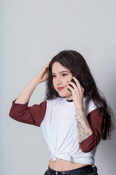 istock women talking on smart phone, studio shot 700209250