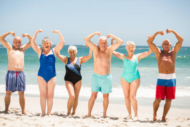 istock Seniors posing with muscles at the beach 700212358