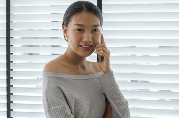 istock asian woman talking telephone in office 700212844