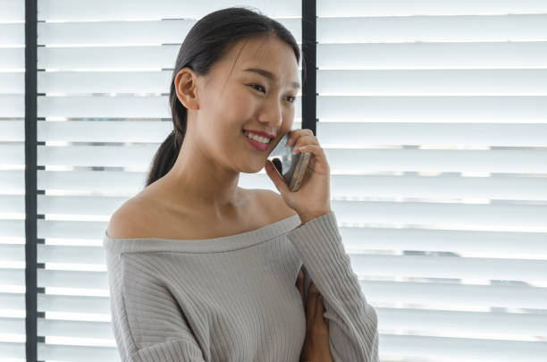 istock asian woman talking telephone in office 700215008